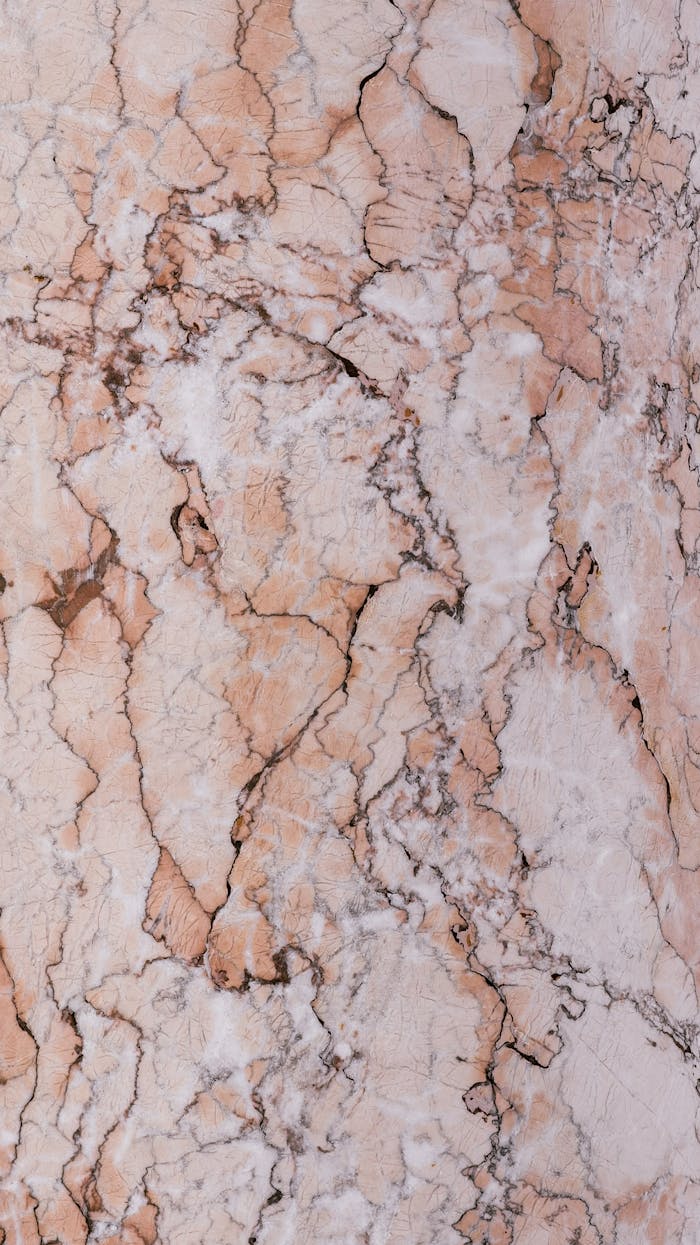 Detailed close-up of cracked marble texture, perfect for backgrounds or artistic designs.