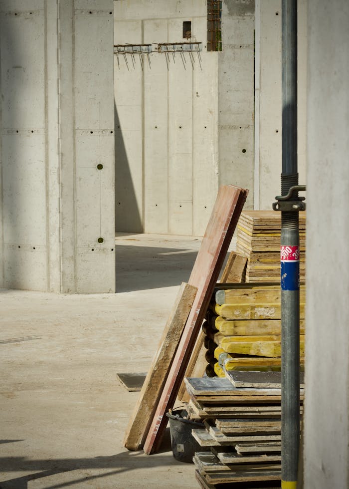 pexels-photo-36162732 Concrete industrial site with stacked building materials and structure in progress.